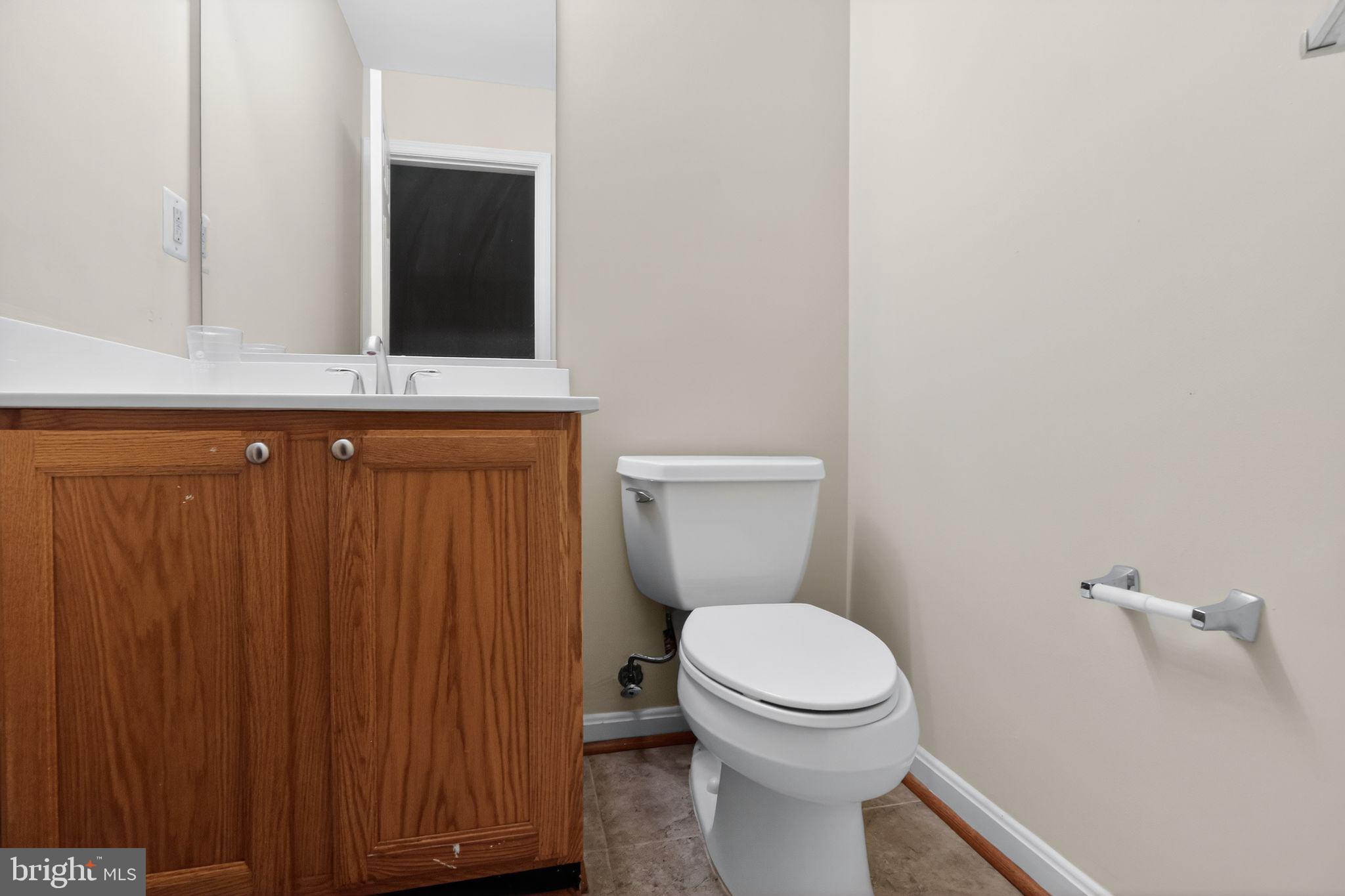 6348 Dakine Circle Springfield, VA 22150 - Photo 33 of 35 a bathroom with a toilet sink and mirror