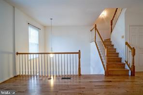 6348 Dakine Circle Springfield, VA 22150 - Photo 7 of 35 a view of staircase with white walls and wooden floor