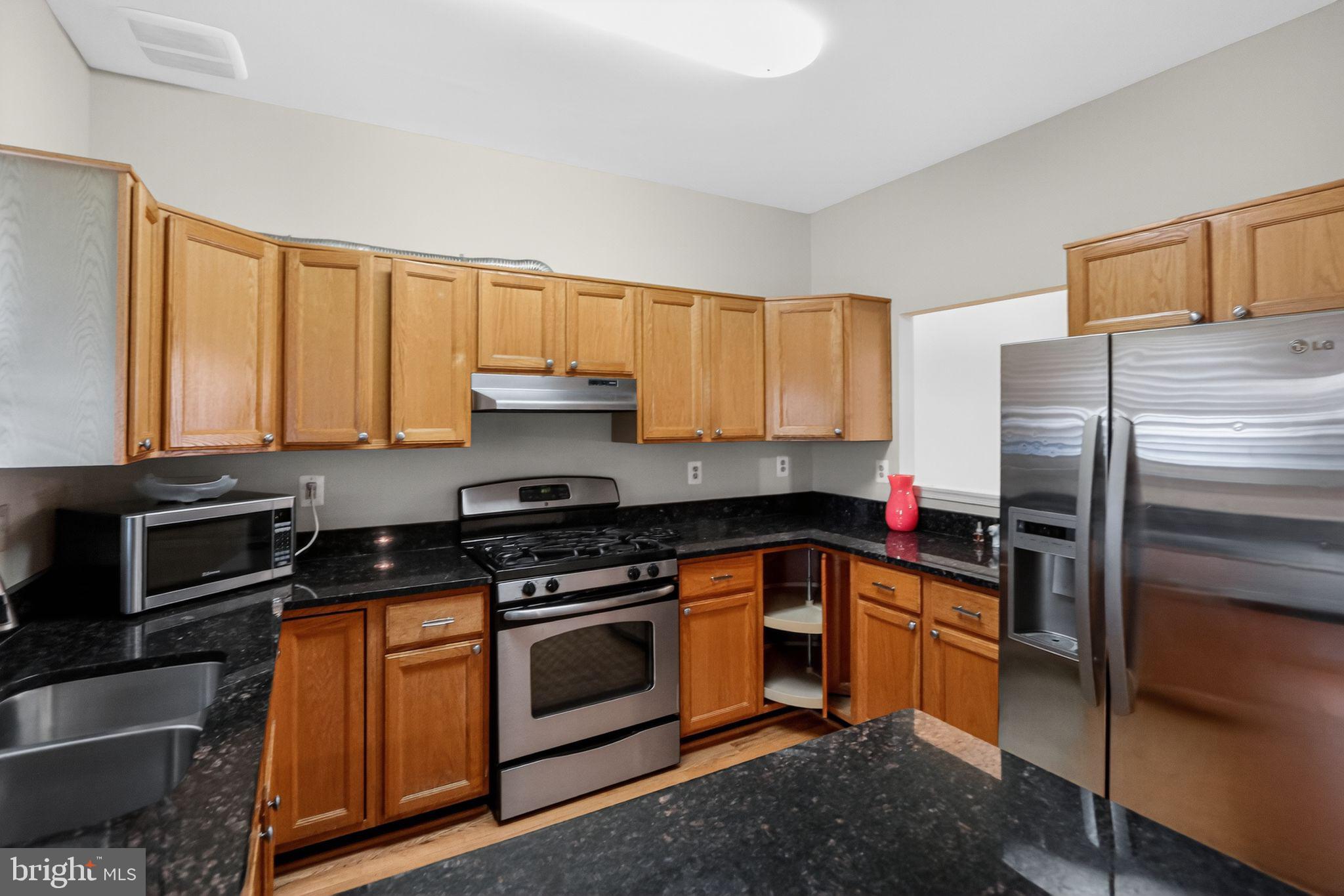 6348 Dakine Circle Springfield, VA 22150 - Photo 8 of 35 a kitchen with a sink stove and refrigerator