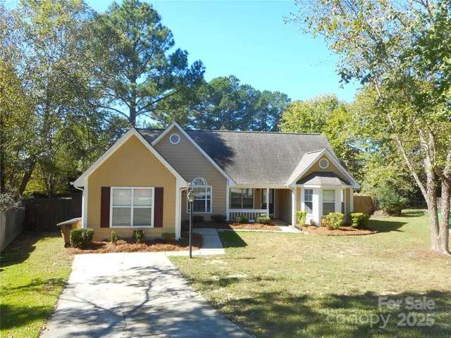 a front view of a house with a yard outdoor seating and garage