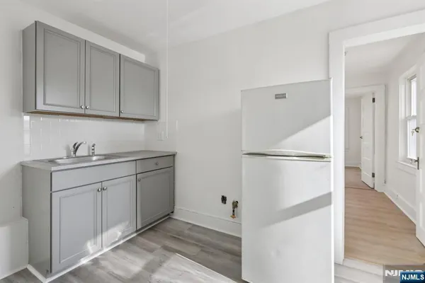 a room with white cabinets and white appliances