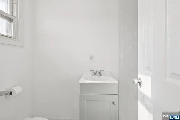 a bathroom with a sink a toilet and a mirror