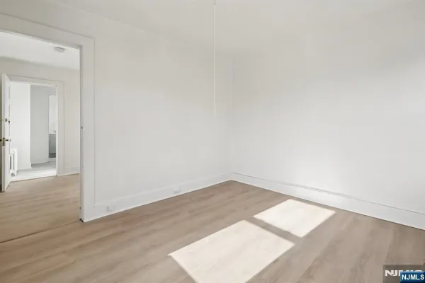 an empty room with wooden floor