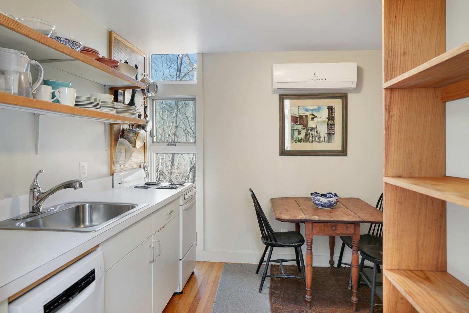 25 Fulling Mill Road Chilmark, MA 02535 - Photo 26 of 31 a kitchen that has a sink a table and chairs in it