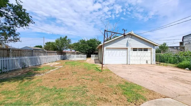 a view of a backyard with a large tree