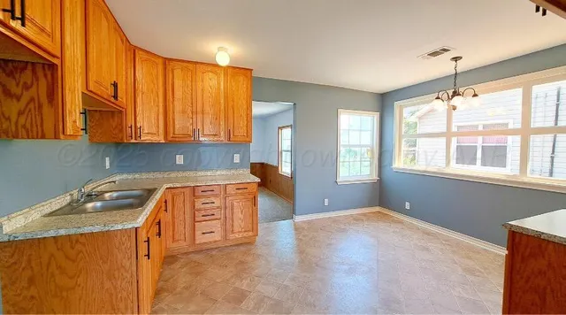 a kitchen that has a sink and a stove