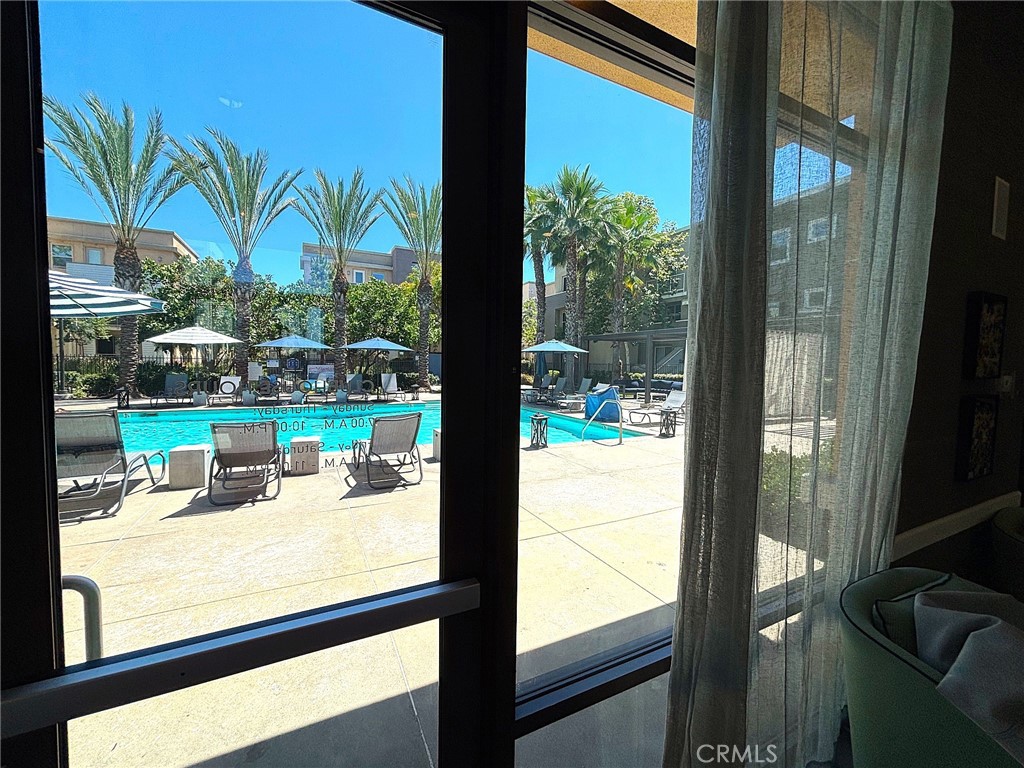 612 East Carson Street, Unit 303 Carson, CA 90745 - Photo 43 of 51 a view of a room with a large window and potted plants