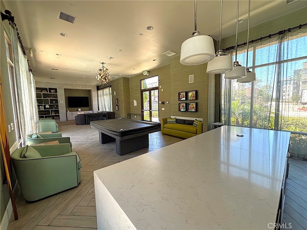 612 East Carson Street, Unit 303 Carson, CA 90745 - Photo 45 of 51 a large living room with stainless steel appliances granite countertop couches a fireplace and a large window with wooden floor