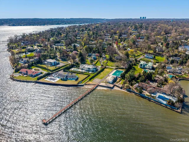 an aerial view of a houses with a ocean view