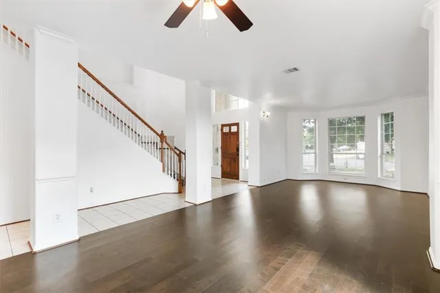 a view of entryway with wooden floor and stairs
