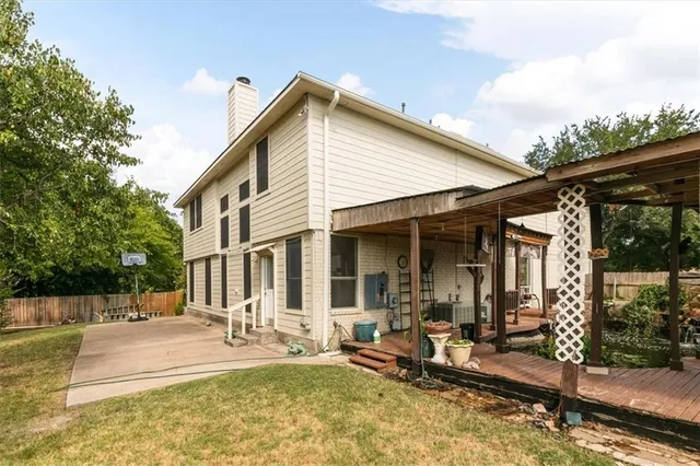 an empty room with wooden floor ceiling fan and window