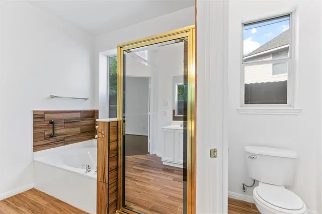 a bathroom with a tub sink and mirror