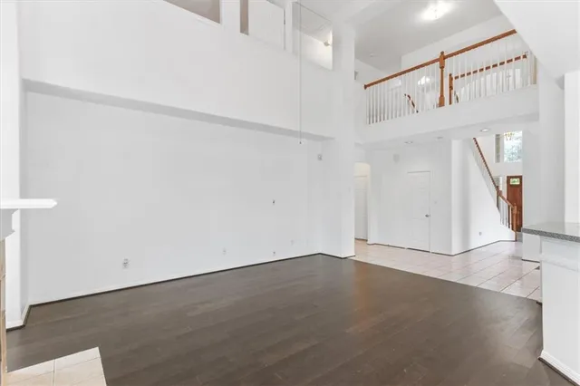 an empty room with wooden floor and white walls