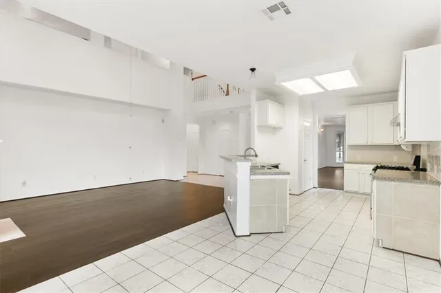 a view of a hallway with wooden floor and entryway