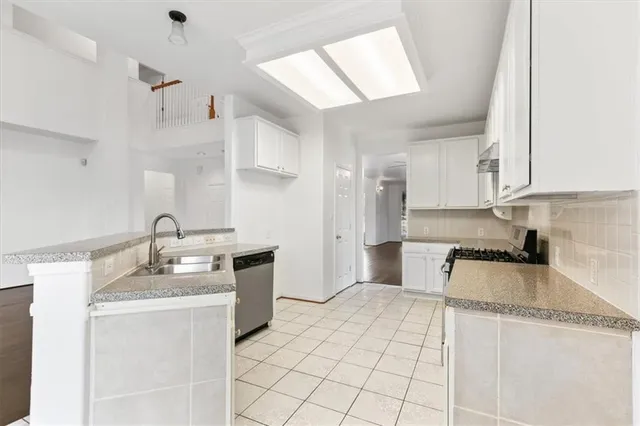 a kitchen with cabinets and a stove