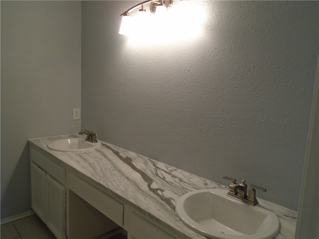 5338 Meadowgate Drive Corpus Christi, TX 78413 - Photo 11 of 15 a bathroom with a granite countertop sink and a mirror