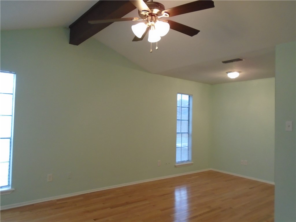 5338 Meadowgate Drive Corpus Christi, TX 78413 - Photo 13 of 15 an empty room with wooden floor fan and windows