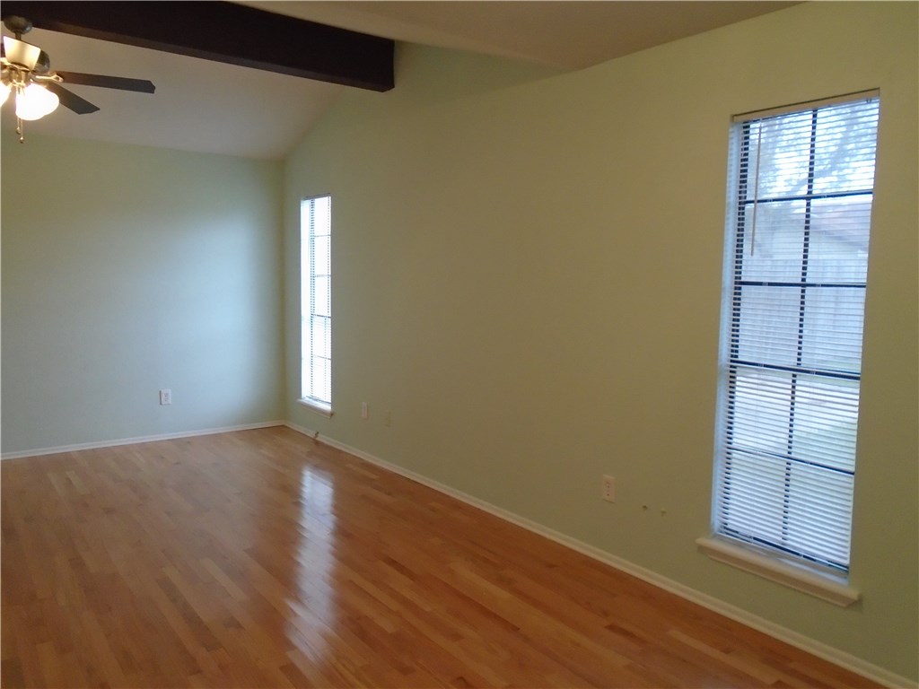 5338 Meadowgate Drive Corpus Christi, TX 78413 - Photo 14 of 15 an empty room with wooden floor and windows