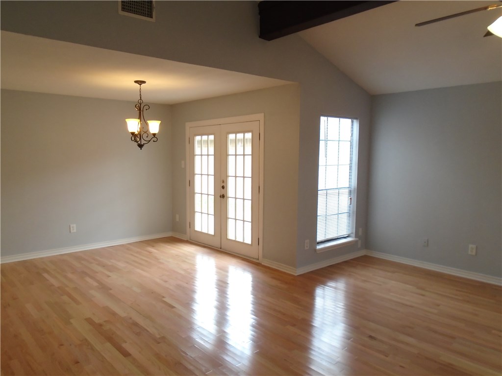 5338 Meadowgate Drive Corpus Christi, TX 78413 - Photo 5 of 15 a view of an empty room with wooden floor and a window