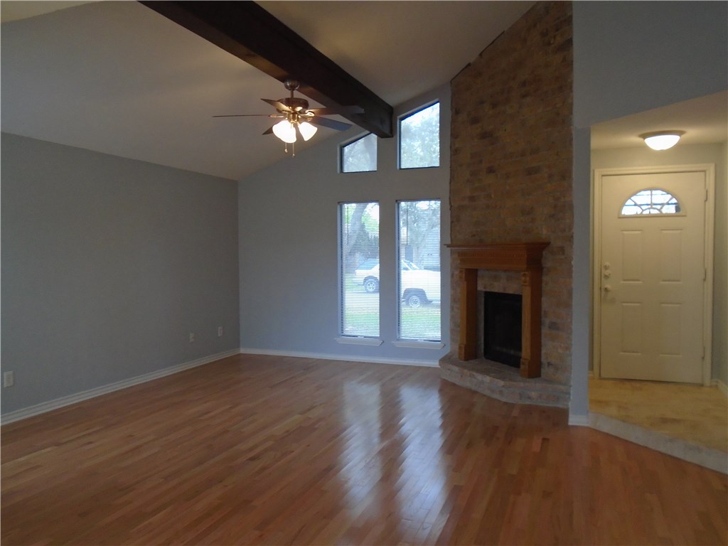 5338 Meadowgate Drive Corpus Christi, TX 78413 - Photo 6 of 15 a view of an empty room with wooden floor and a fireplace