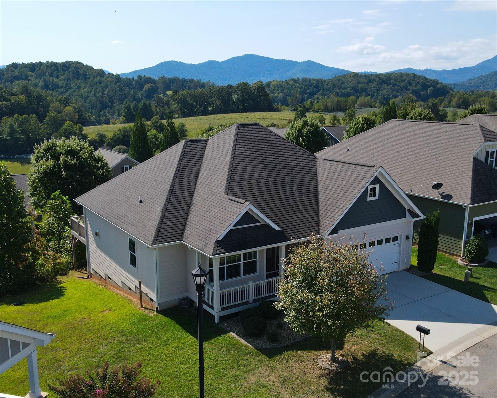 an aerial view of a house with big yard