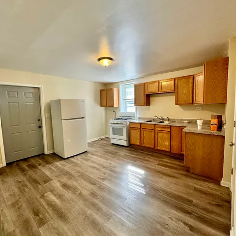 a view of kitchen with wooden floor