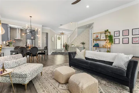 a living room with furniture a rug and a chandelier