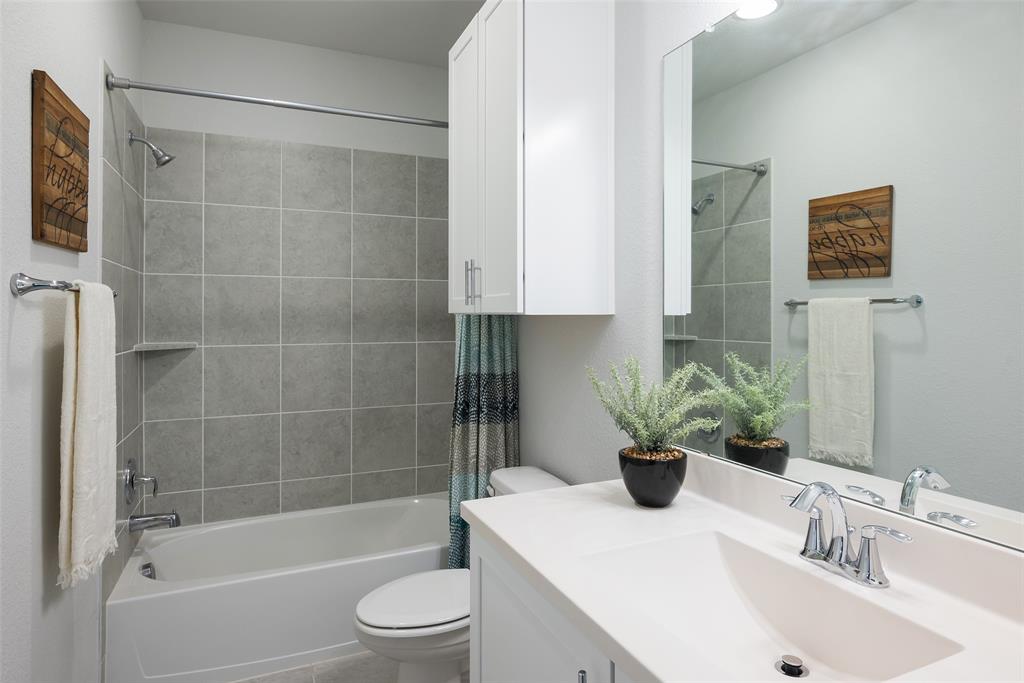1115 Manacor Lane Dallas, TX 75212 - Photo 26 of 28 a bathroom with a sink a toilet and shower