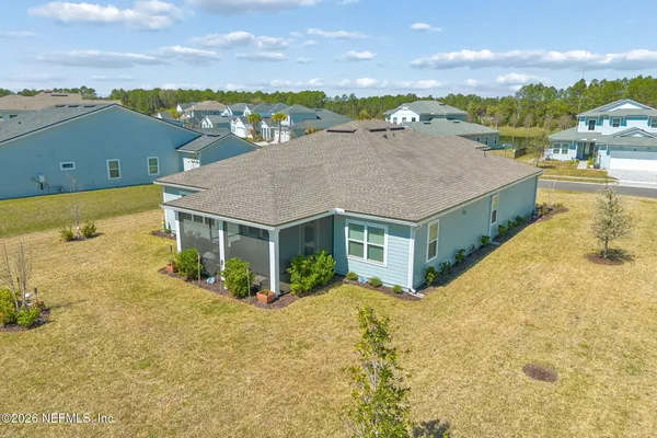 an aerial view of a house a table and chairs