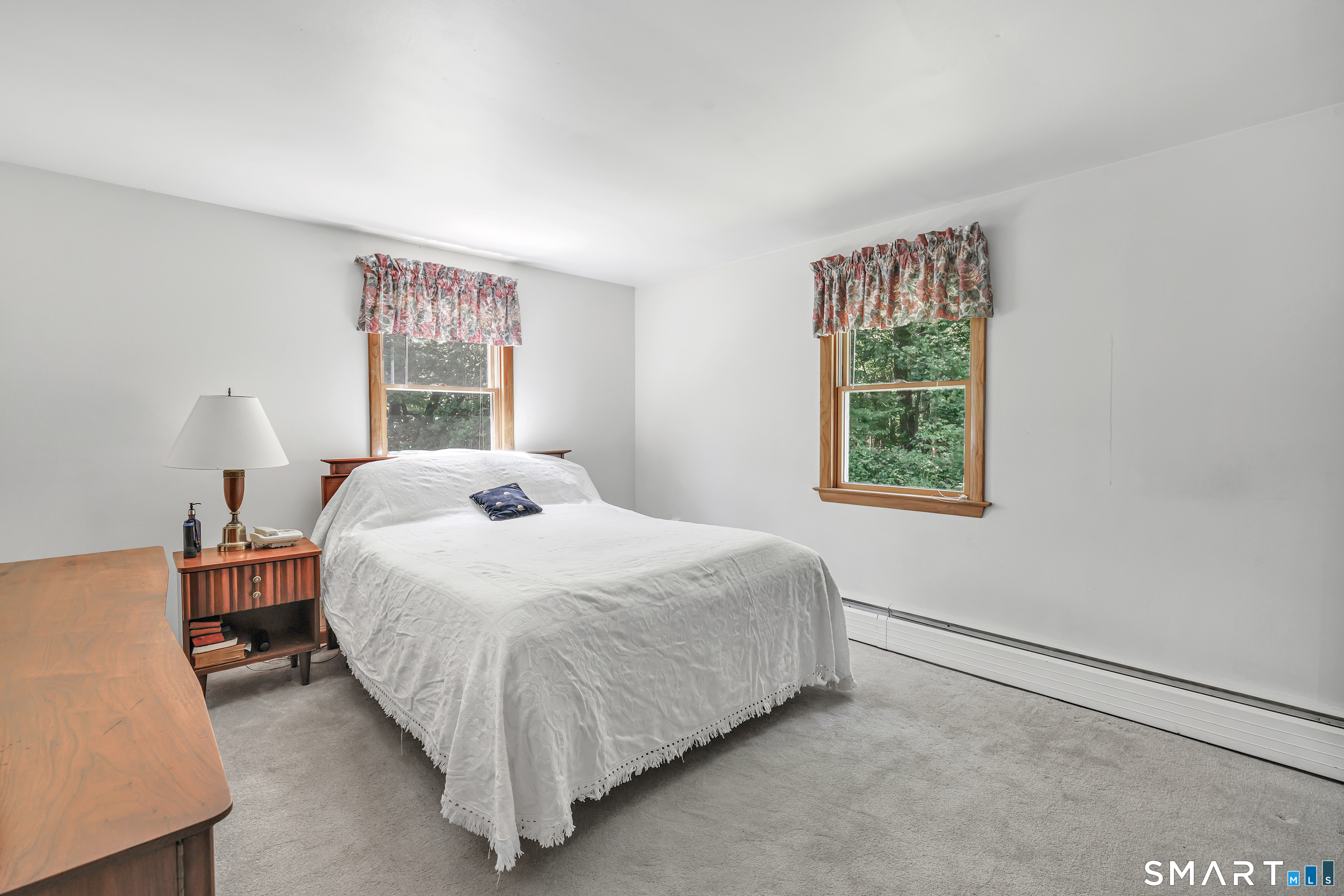 223 Wheeler Road Monroe, CT 06468 - Photo 18 of 35 a bed sitting in a bedroom next to a window