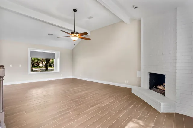 a view of a livingroom with a flat screen tv and a ceiling fan