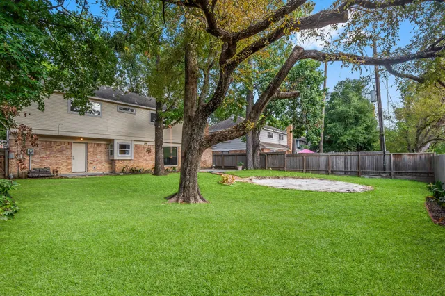 a view of a house with a backyard