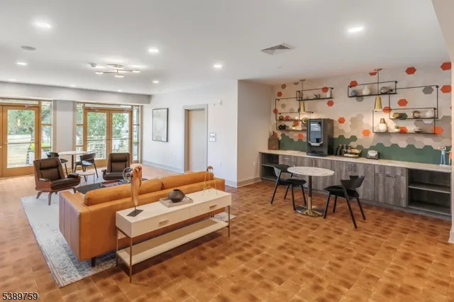 a living room with fireplace furniture and a large window