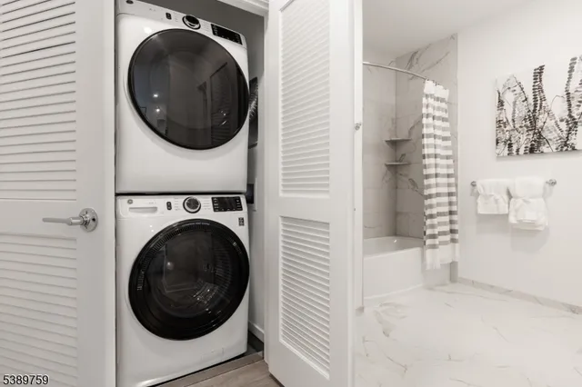 a view of a hallway with washer and dryer