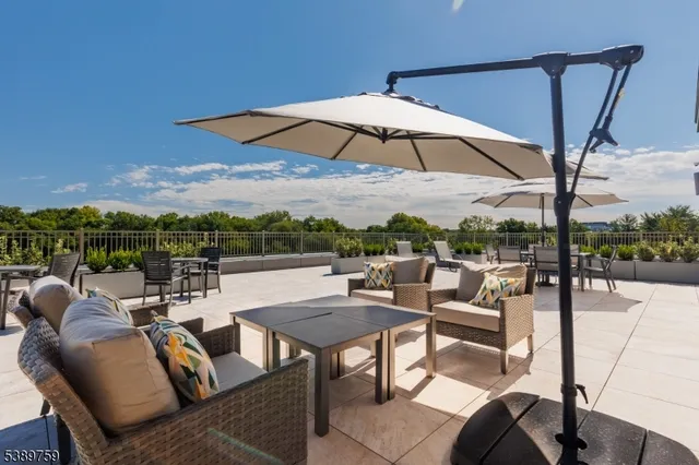 a view of a terrace with furniture and a yard