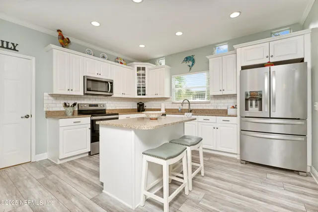 a kitchen with granite countertop stainless steel appliances and sink
