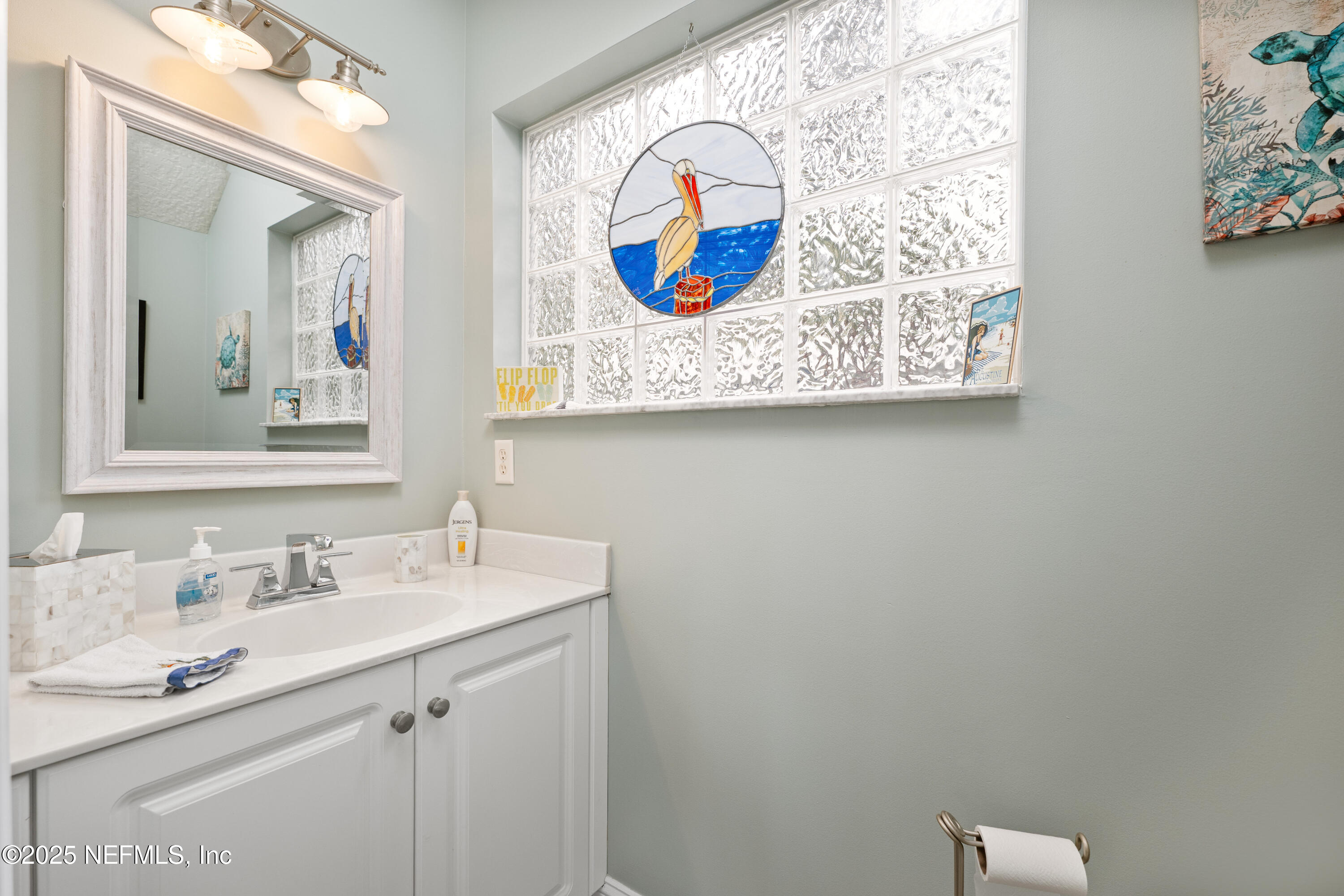 2500 Hydrangea Street St. Augustine, FL 32080 - Photo 19 of 56 a bathroom with a sink and a mirror