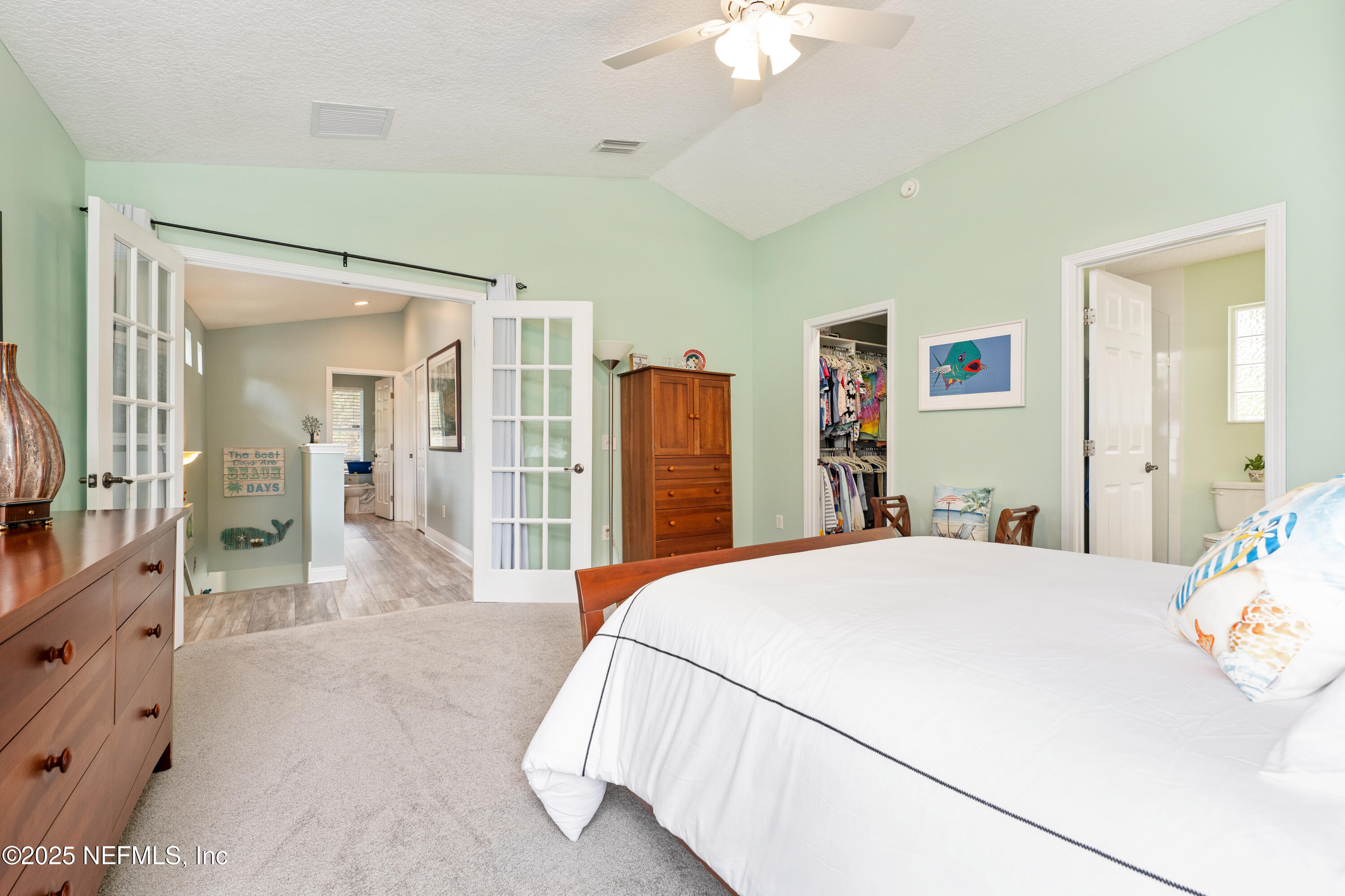 2500 Hydrangea Street St. Augustine, FL 32080 - Photo 23 of 56 a bedroom with a bed and a chandelier