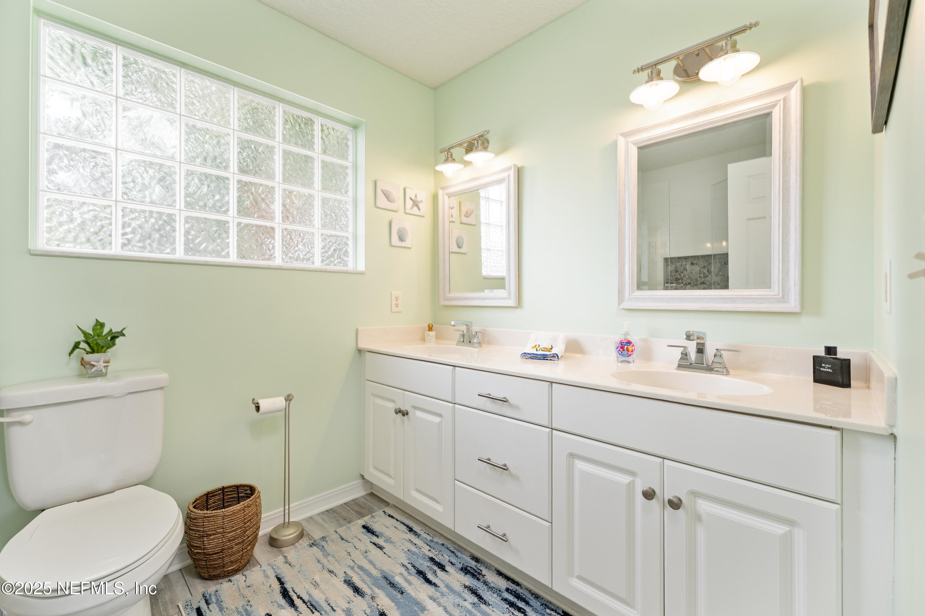 2500 Hydrangea Street St. Augustine, FL 32080 - Photo 24 of 56 a bathroom with a toilet sink and mirror