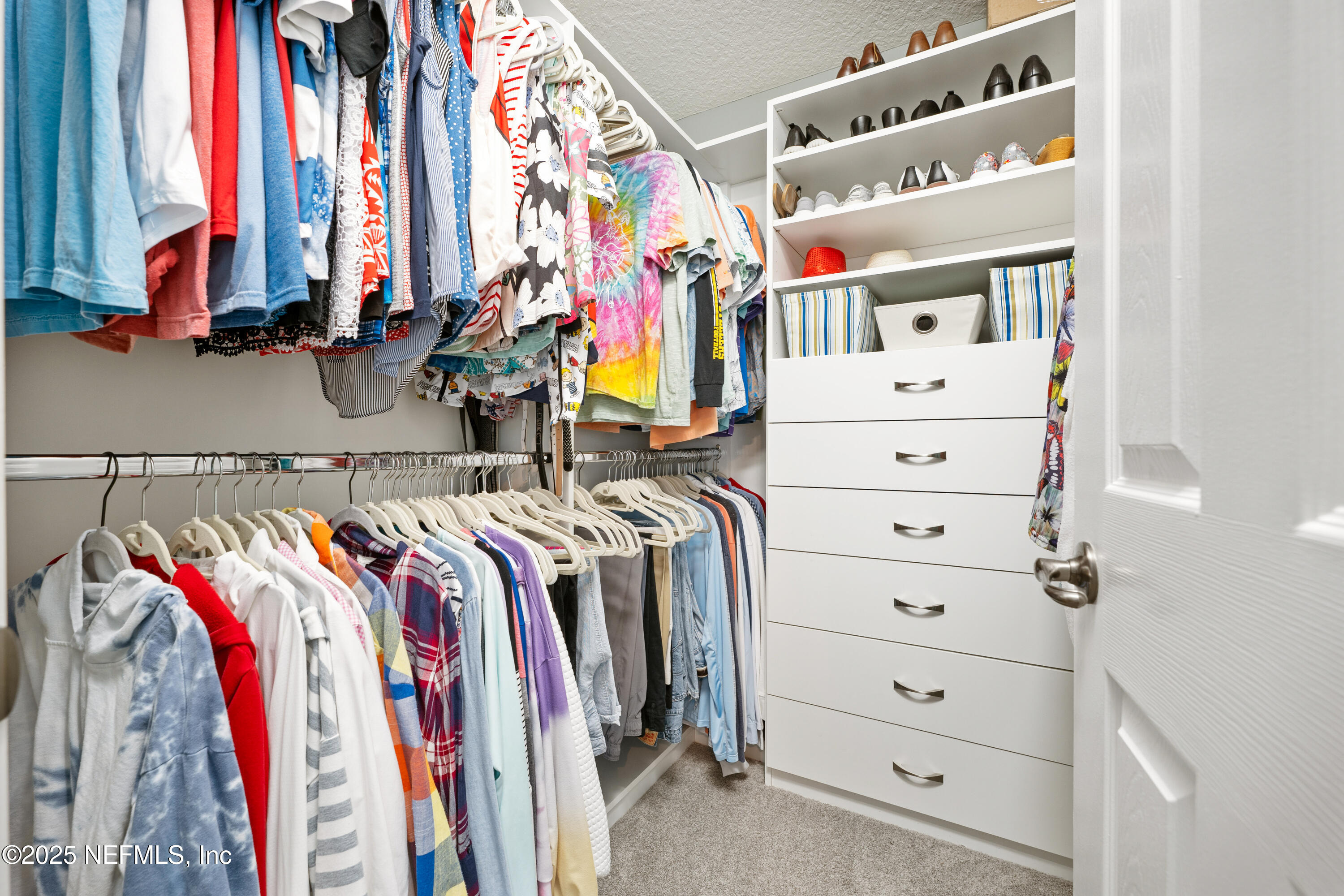 2500 Hydrangea Street St. Augustine, FL 32080 - Photo 26 of 56 a view of walk in closet with clothes and shoes