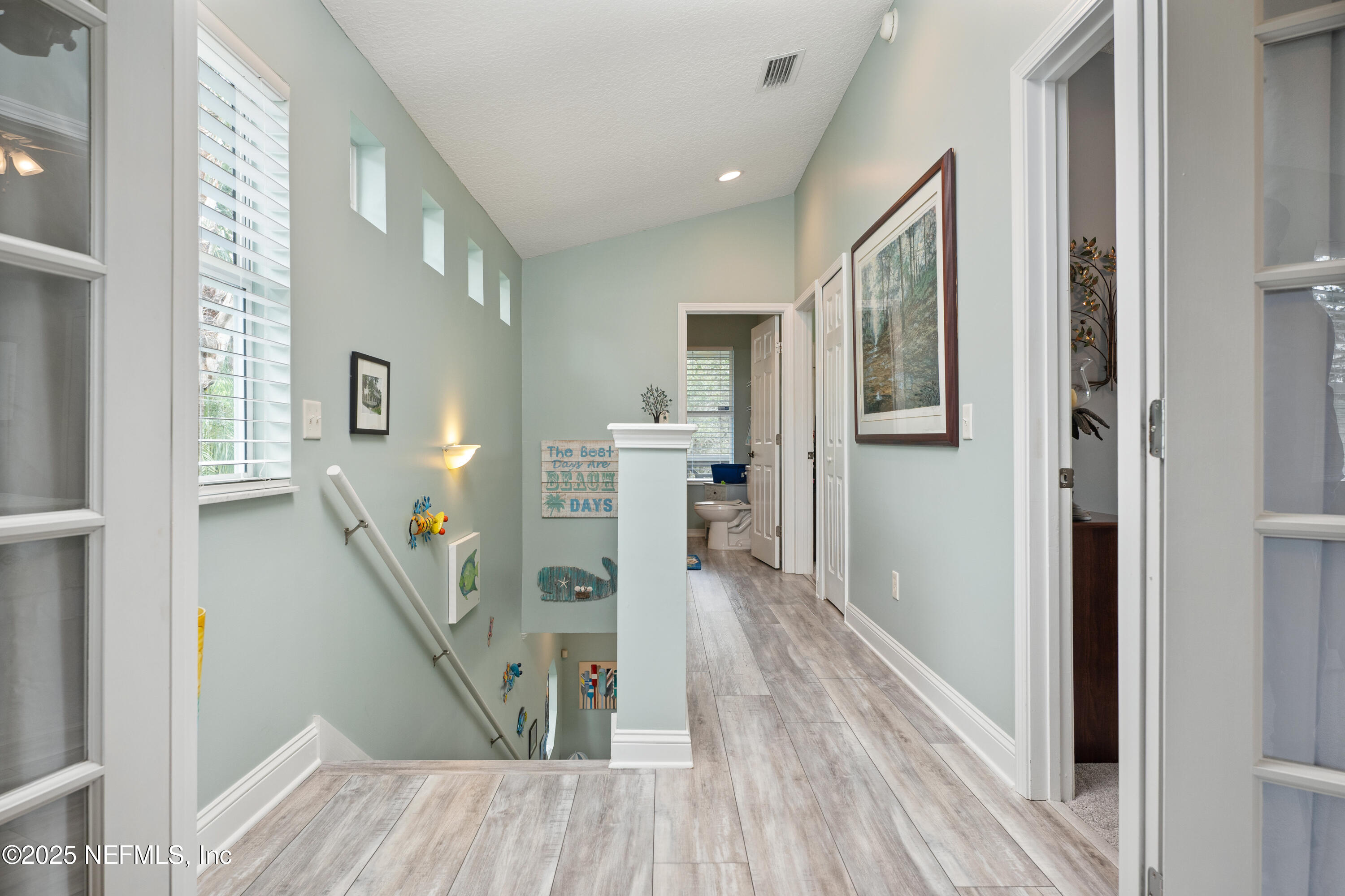 2500 Hydrangea Street St. Augustine, FL 32080 - Photo 27 of 56 a view of a hallway with wooden floor and staircase