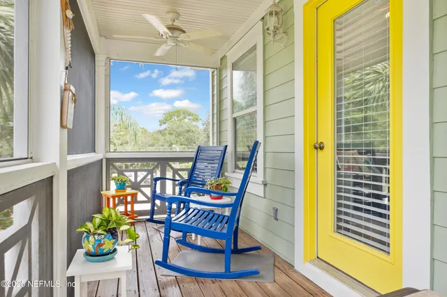 a view of a backyard with a table and chairs under an umbrella