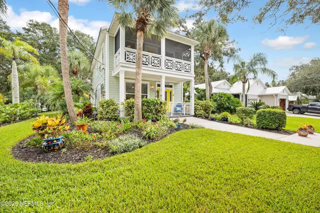 a front view of a house with a yard and fountain in middle