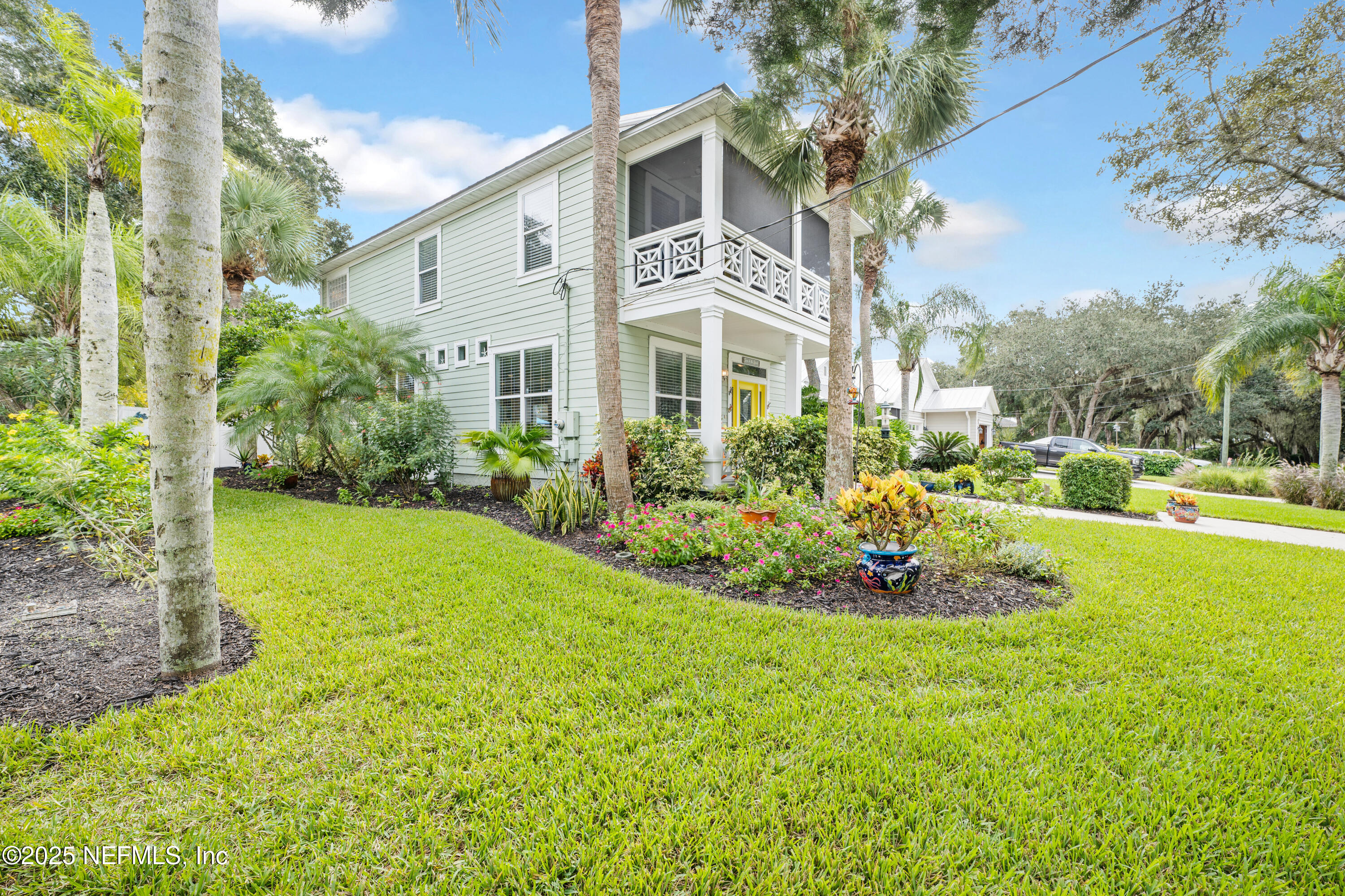 2500 Hydrangea Street St. Augustine, FL 32080 - Photo 5 of 56 a front view of a house with a yard and fountain in middle
