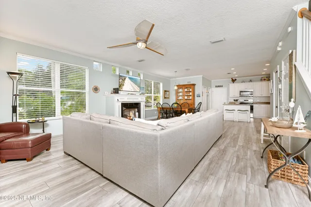 a dining room with furniture a rug and wooden floor