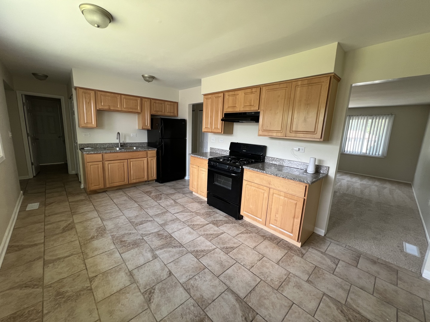 537 Nathan Road University Park, IL 60484 - Photo 6 of 27 a kitchen with stainless steel appliances granite countertop a stove a sink and a refrigerator