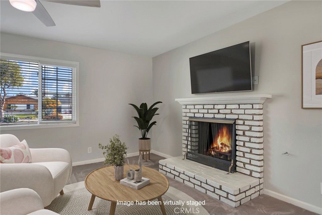 1115 South Groveland Place Anaheim, CA 92806 - Photo 12 of 42 a living room with furniture a flat screen tv and a fireplace