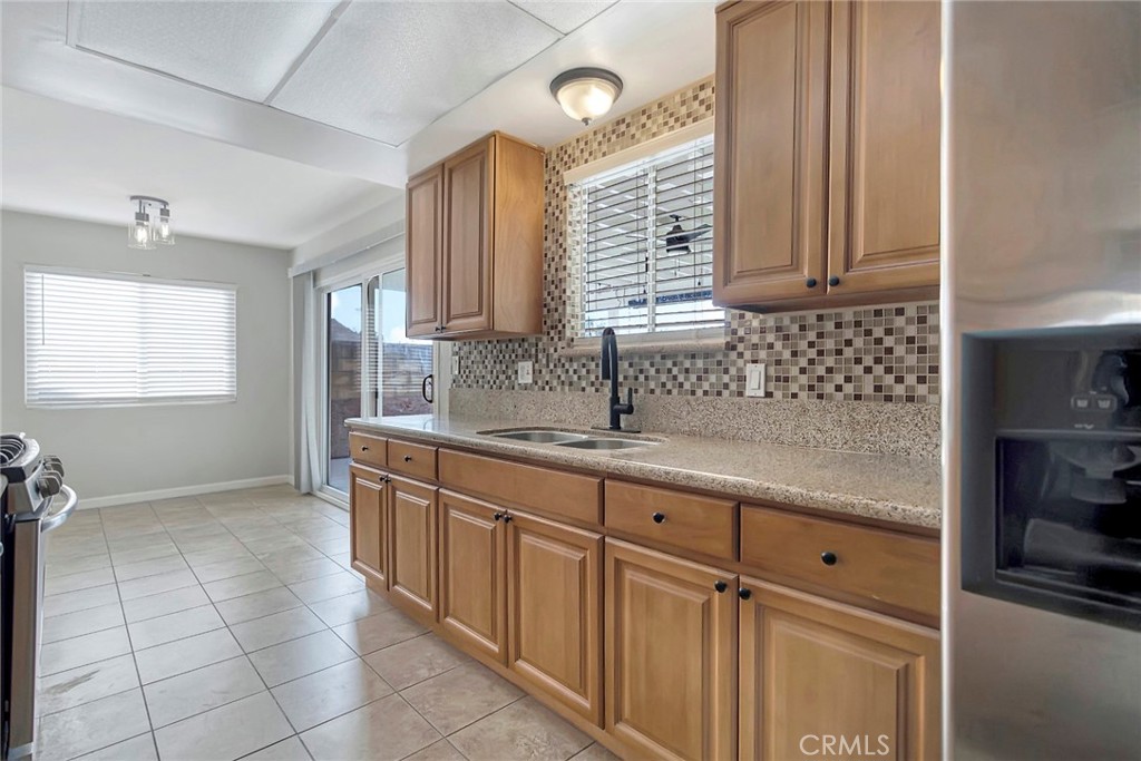 1115 South Groveland Place Anaheim, CA 92806 - Photo 15 of 42 a kitchen with a sink window and cabinets