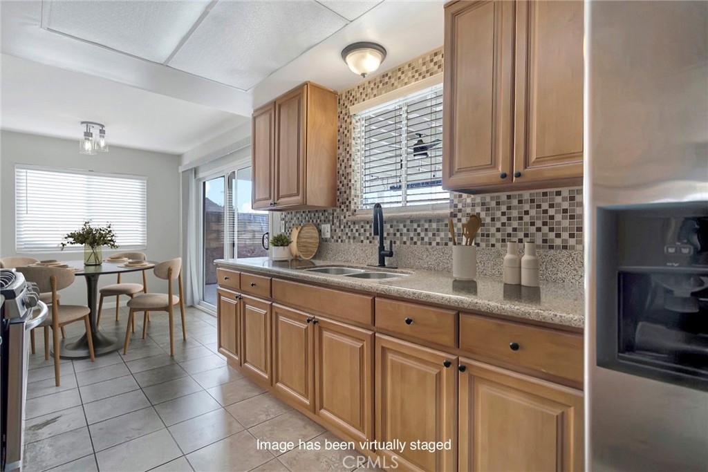 1115 South Groveland Place Anaheim, CA 92806 - Photo 16 of 42 a kitchen with granite countertop a sink and cabinets