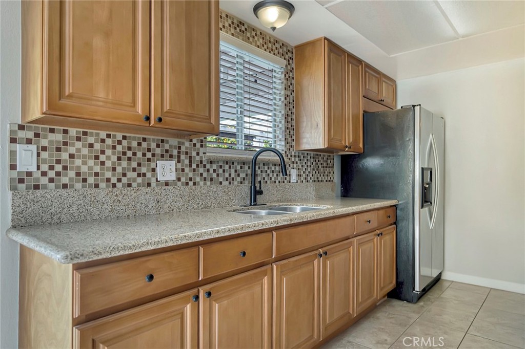 1115 South Groveland Place Anaheim, CA 92806 - Photo 21 of 42 a kitchen with stainless steel appliances granite countertop a sink and cabinets